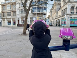 A young girl looking into the past at the Buttermarket